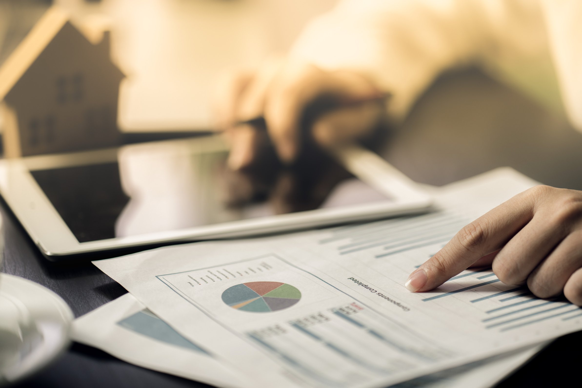 Hand of Business people calculating interest, taxes and profits to invest in real estate and home buying