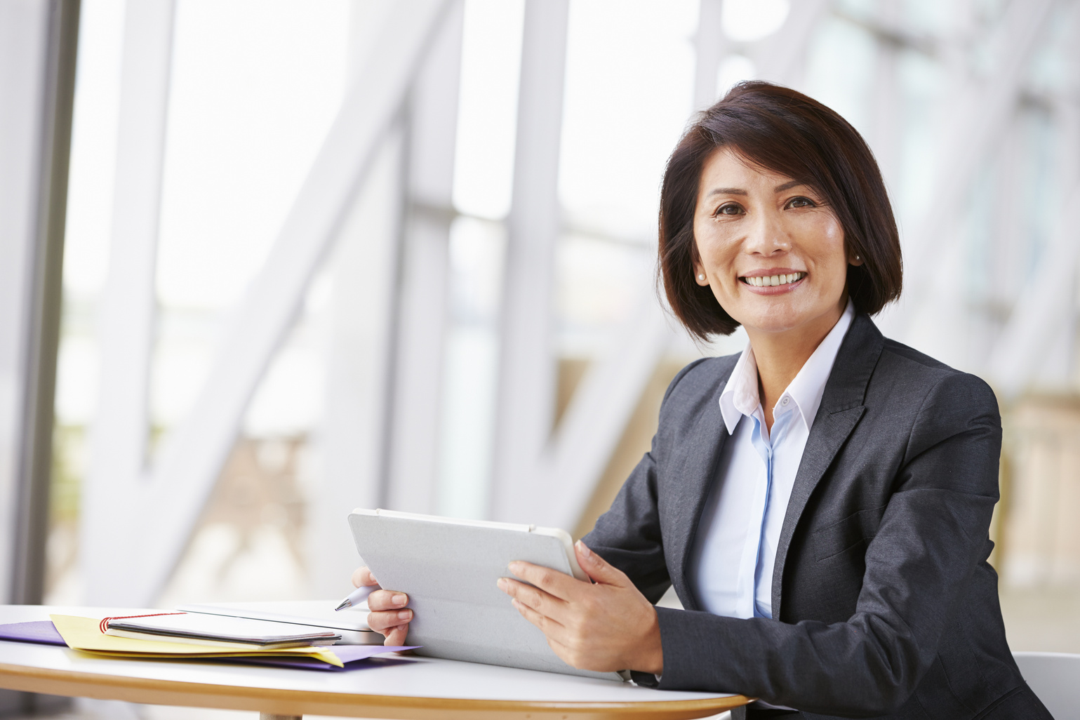 Portrait of a Tenured Employee with a Tablet